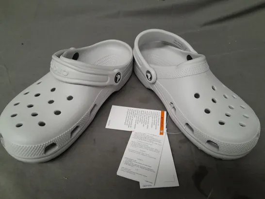 PAIR OF CROCS CLASSICS IN GREY UK SIZE M5/W6