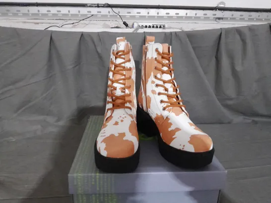 BOXED PAIR OF KOI COW PRINT BOOTS SIZE 6