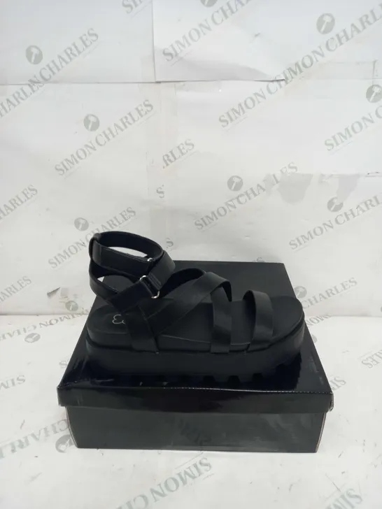 BOXED PAIR OF KOI FOOTWEAR CRIX CHUNKY BLATFORM SANDALS IN BLACK PU - SIZE 6