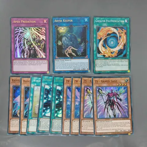 SMALL ASSORTMENT OF YU-GI-OH COLLECTIBLE TRADING CARDS TO INCLUDE APEX PREDATION, ABYSS KEEPER, GREATER POLYMERIZATION, ETC