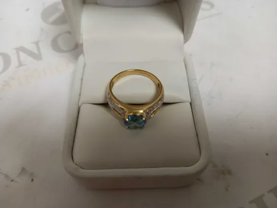 DESIGNER 9CT YELLOW GOLD RING SET WITH A BLUE TOPAZ AND DIAMONDS WEIGHING +-2.10CT