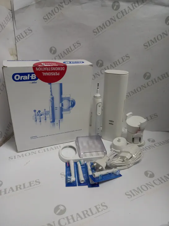 BOXED BRAUN ORAL-B DENTAL KIT TO INCLUDE RECHARGEABLE TOOTHBRUSH, TRAVEL CASE, CHARGING STATION, SMARTPHONE HOLDER, AND BRUSH HEADS