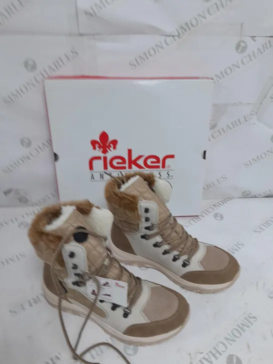 BOXED PAIR OF RIEKER CREAM WINTER FUR HIKE BOOTS IN SIZE 6