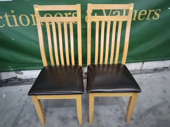 PAIR OF WOODEN DINING CHAIRS WITH BLACK FAUX LEATHER SEAT PADS 