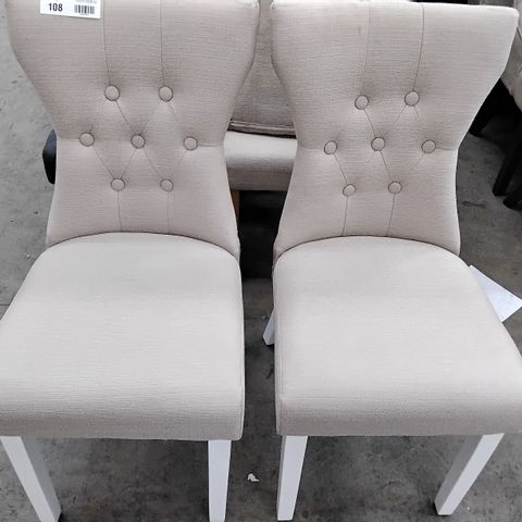 2 DESIGNER CREAM FABRIC CHAIRS WITH BUTTONED BACK, AND WHITE LEGS