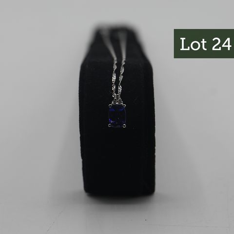 DESIGNER 18ct PENDANT ON CHAIN SET WITH AN OVAL TANZANITE WITH DIAMOND ACCENTS, WEIGHING +-1.44ct