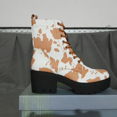 BOXED PAIR OF KOI COW PRINT BOOTS SIZE 6