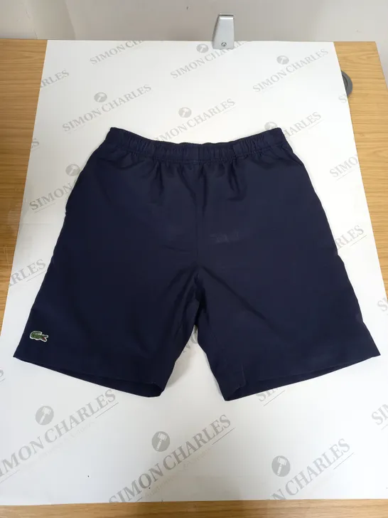 LACOSTE SPORTS SHORTS IN NAVY - SIZE 16