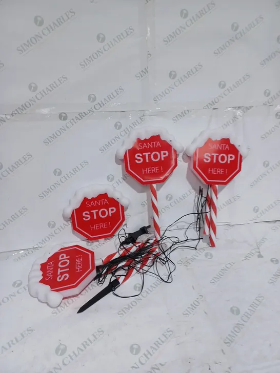 FESTIVE SET OF 4 PRE-LIT SANTA STOP HERE 58CM STAKES