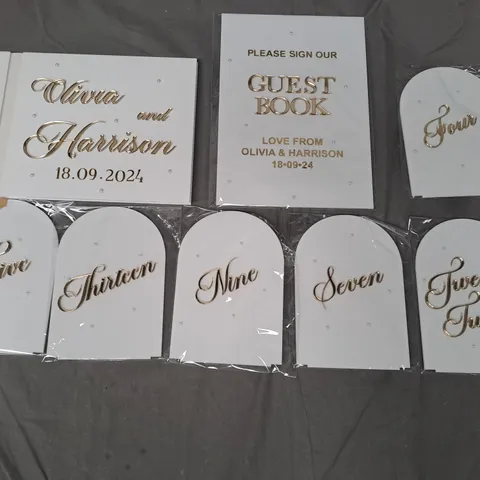 BOX OF APPROXIMATELY 20 PERSONALISED WEDDING TABLE NUMBERS AND GUEST BOOK