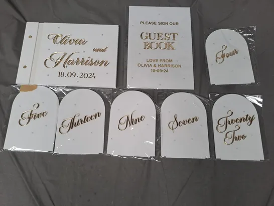 BOX OF APPROXIMATELY 20 PERSONALISED WEDDING TABLE NUMBERS AND GUEST BOOK