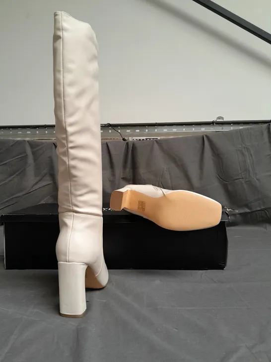 BOXED PAIR OF PRETTYLITTLETHING CREAM HEELED BOOTS SIZE UK 9