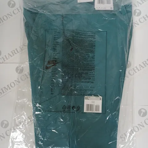 NIKE SLIM FIT TAPERED PANTS IN TEAL SIZE XS