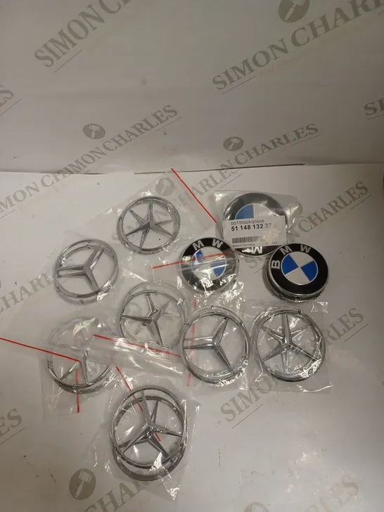 BOX OF APPROXIMATELY 15 BMW & MERCEDES BENZ REPLACEMENT PLASTIC BADGES 