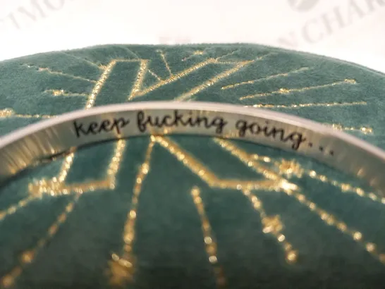 BRACELET INSCRIBED 'KEEP F***ING GOING'