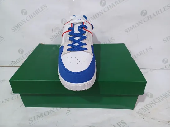 BOXED PAIR OF LACOSTE SHOES IN WHITE/BLUE/RED UK SIZE 10