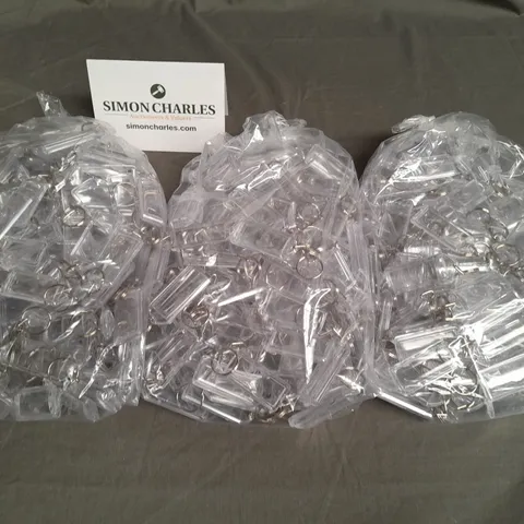 LOT OF 8 MULTIPACK BAGS OF CLEAR KEYRINGS