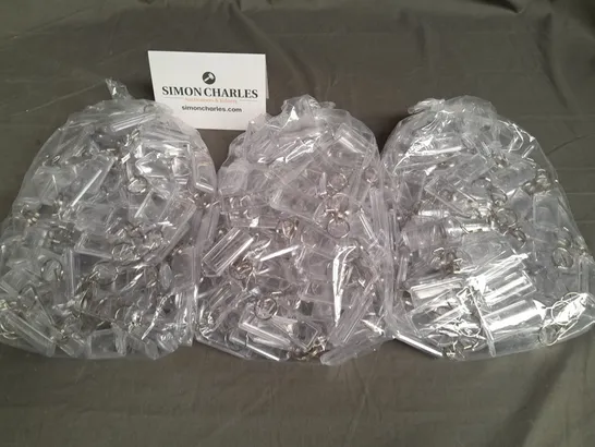 LOT OF 8 MULTIPACK BAGS OF CLEAR KEYRINGS