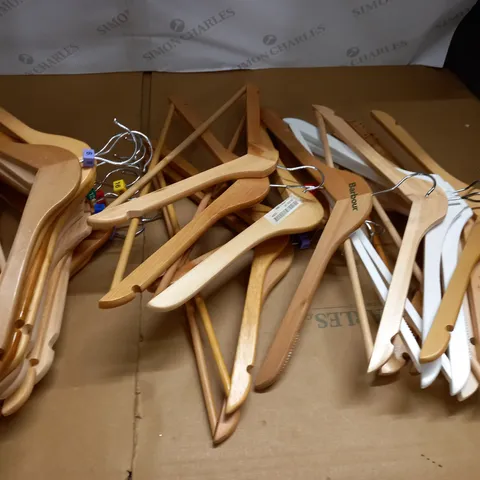 large quantity of assorted wooden clothes hangers in plastic crate