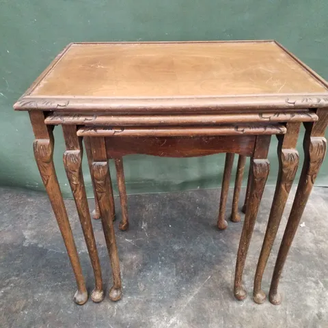 ANTIQUE WALNUT VENEER NEST OF THREE GLASS-TOPPED TABLES 