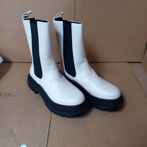 PAIR OF "TRUFFLE COLLECTION" MID-CALF WEDGE BOOTS IN OFF-WHITE AND BLACK, UK SIZE 8