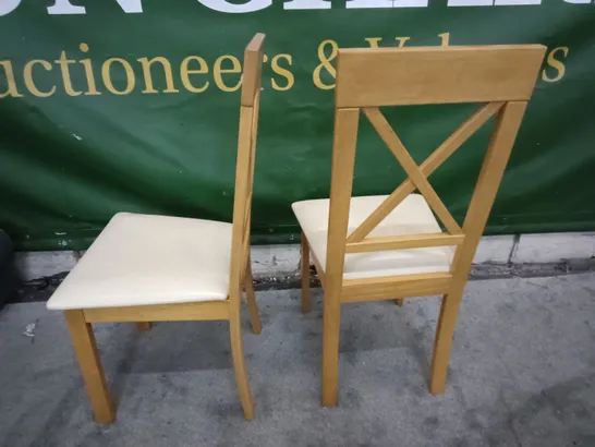 PAIR OF WOODEN DINING CHAIRS WITH CREAM FAUX LEATHER SEAT PADS 