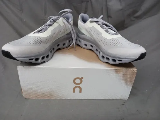 BOXED PAIR OF ON CLOUDMONSTER SHOES IN ICE/ALLOY UK SIZE 11