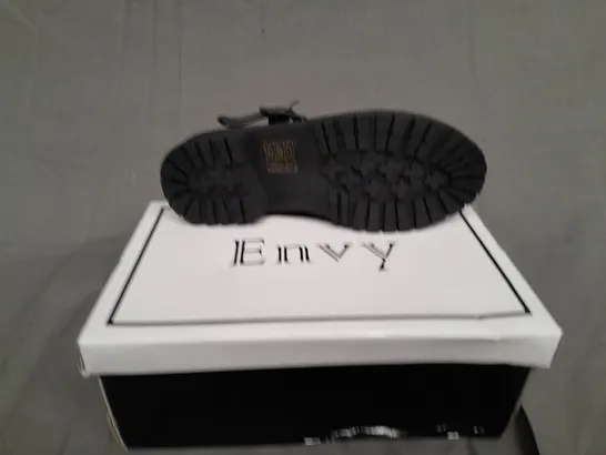 BOXED PAIR OF ENVY SIZE 31 BLACK PATENT BUCKLE TRAINER 
