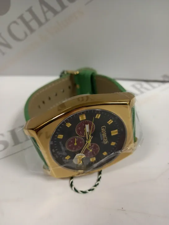 BOXED GAMAGES RETRO CALIBRE GOLD EFFECT CASE GREEN STRAP WATCH 